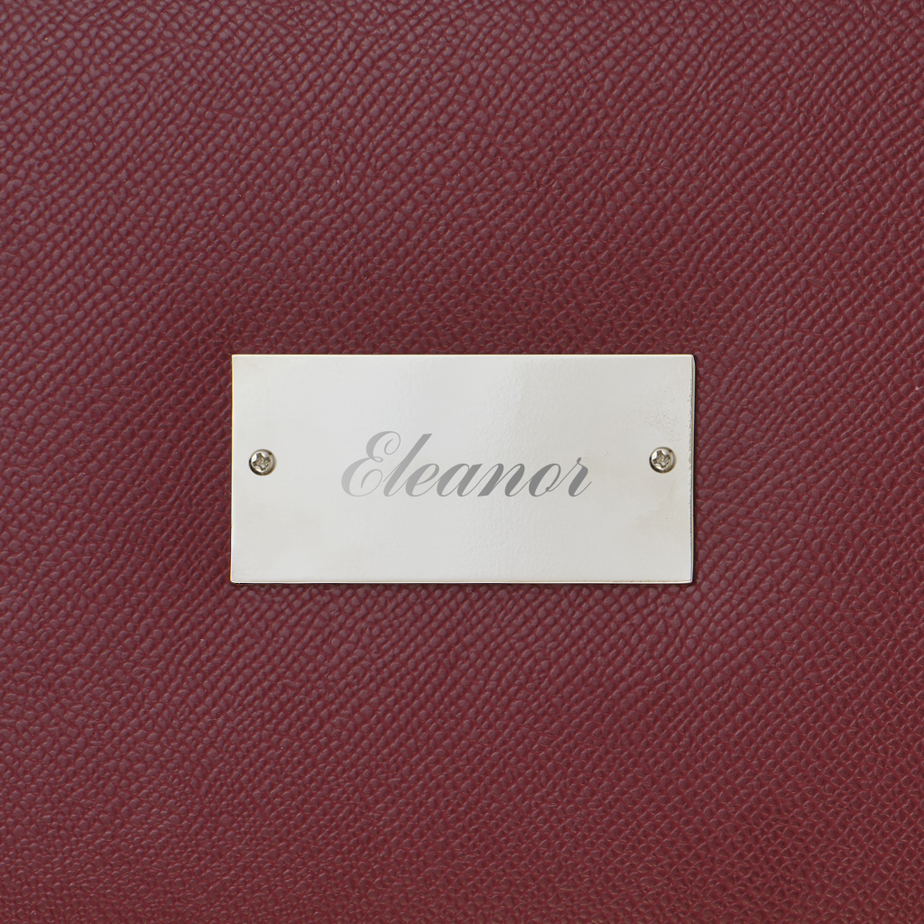 Maroon textured surface with a silver nameplate labeled 'Eleanor'.