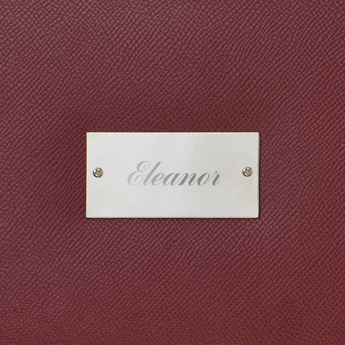 Maroon textured surface with a silver nameplate labeled 'Eleanor'.