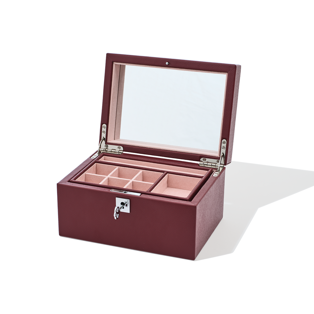Wooden jewelry box with glass lid on a white background