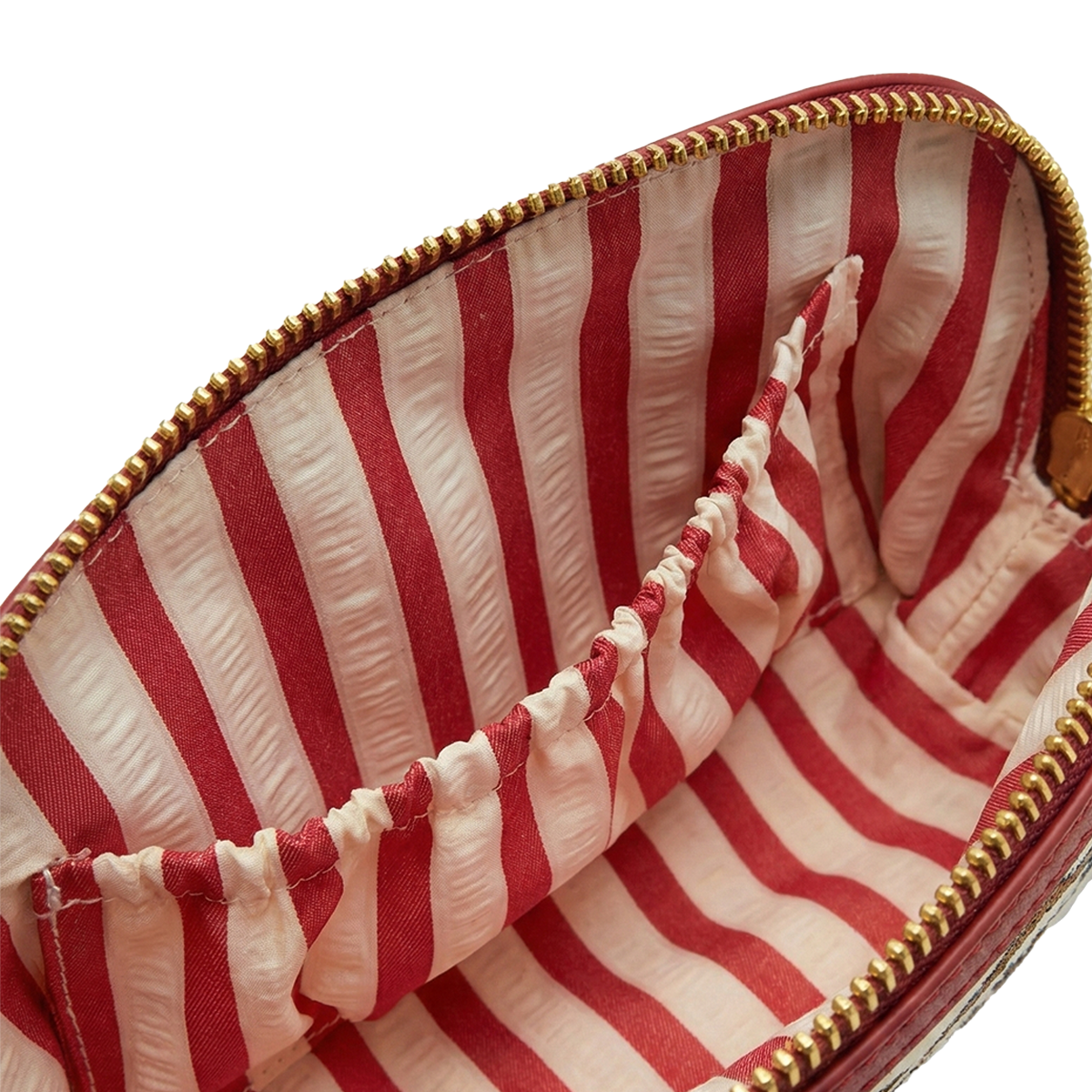Close-up of a red and white striped pouch with gold zipper.